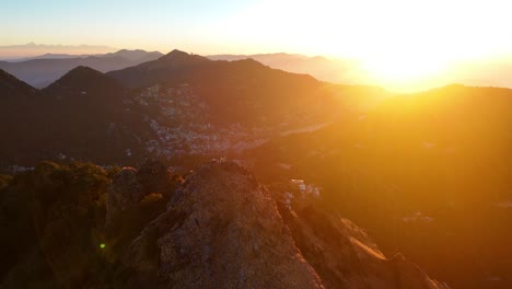 aerial drone shot capturing the tranquil beauty of a nainital morning, with sunlight painting the hills in warm tones.