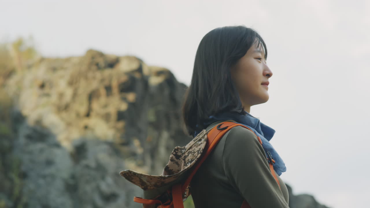 Asian Girl Trekking in Mountains