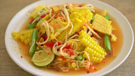 som tum - thai spicy papaya salad with corn - asian food style