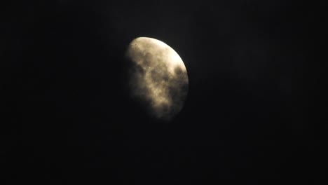 moon at night with cloud real time. 4k video moon in the black sky.  clouds passing by moon at night. night sky with cloudy weather