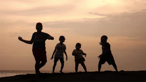 the joy of children dancing on the beach at sunset in the afternoon