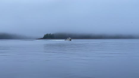 A-shot-of-a-fishing-boat-coming-into-the-harbor-near-Ketchikan-Alaska-on-a-foggy-morning