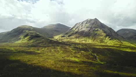 Sun-Lights-Up-Mountainous-Valley-On-A-Cloudy-Day-In-Scotland,-Rannoch-Moor