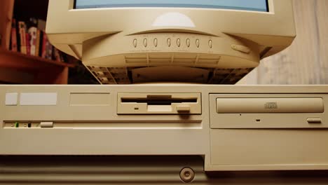 inserting a floppy disk into a vintage computer