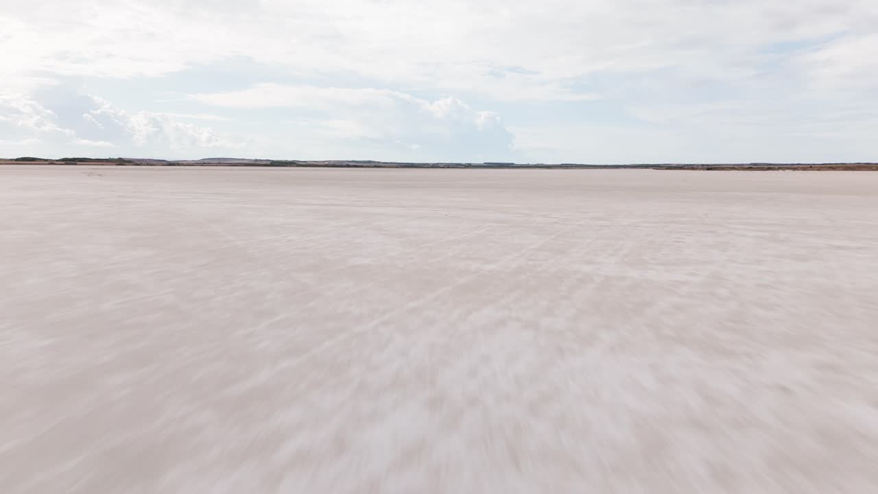 Vast Salt Flat Landscape under a Cloudy Sky