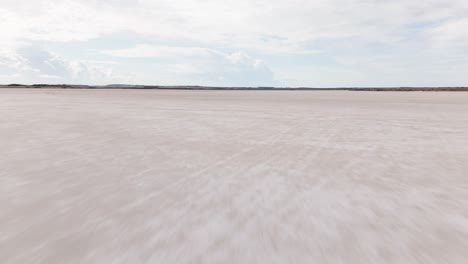 vast salt flat landscape under a cloudy sky