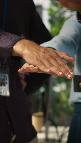 vertical video motivated coworkers in diverse office starting project, showing enthusiasm