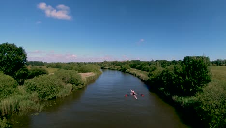 Aerial-Drone-Footage-of-a-boat-along-the-River-Waveney,-Norfolk