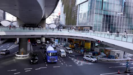 vehicles and pedestrians navigating a busy intersection