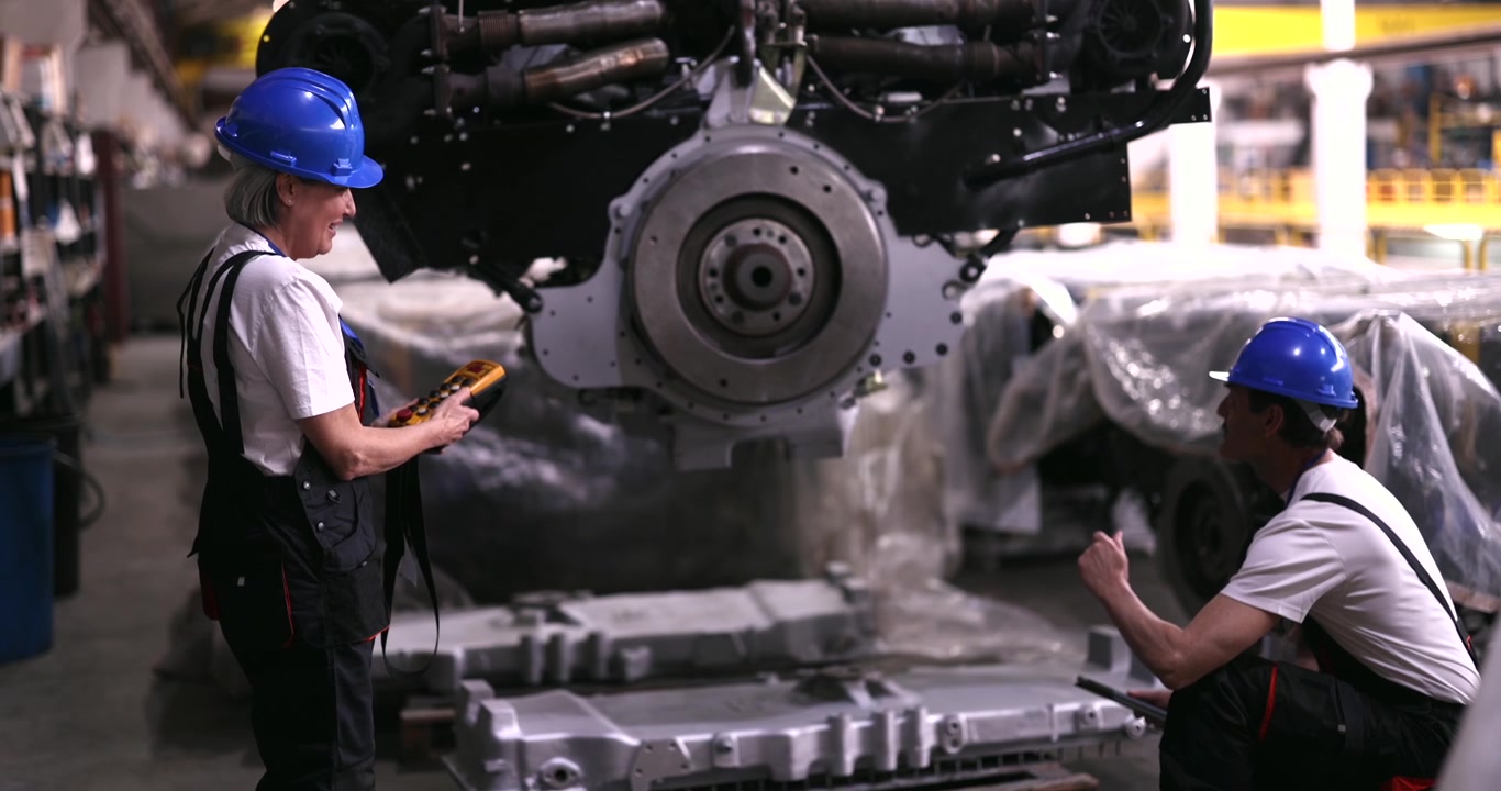 Engineers Inspecting Large Industrial Engine in Manufacturing Facility