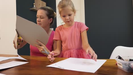 mother and daughter doing a craft project together