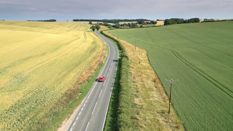 Drone-captures-Lincolnshire-countryside,-farms,-fields,-wheat,-barley,-country-road