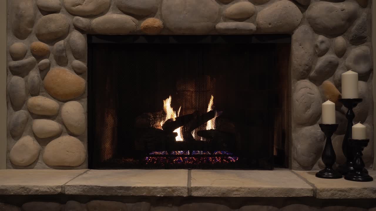 Man starting up a gas fireplace during Winter in Michigan, United States. Shot in 4K.