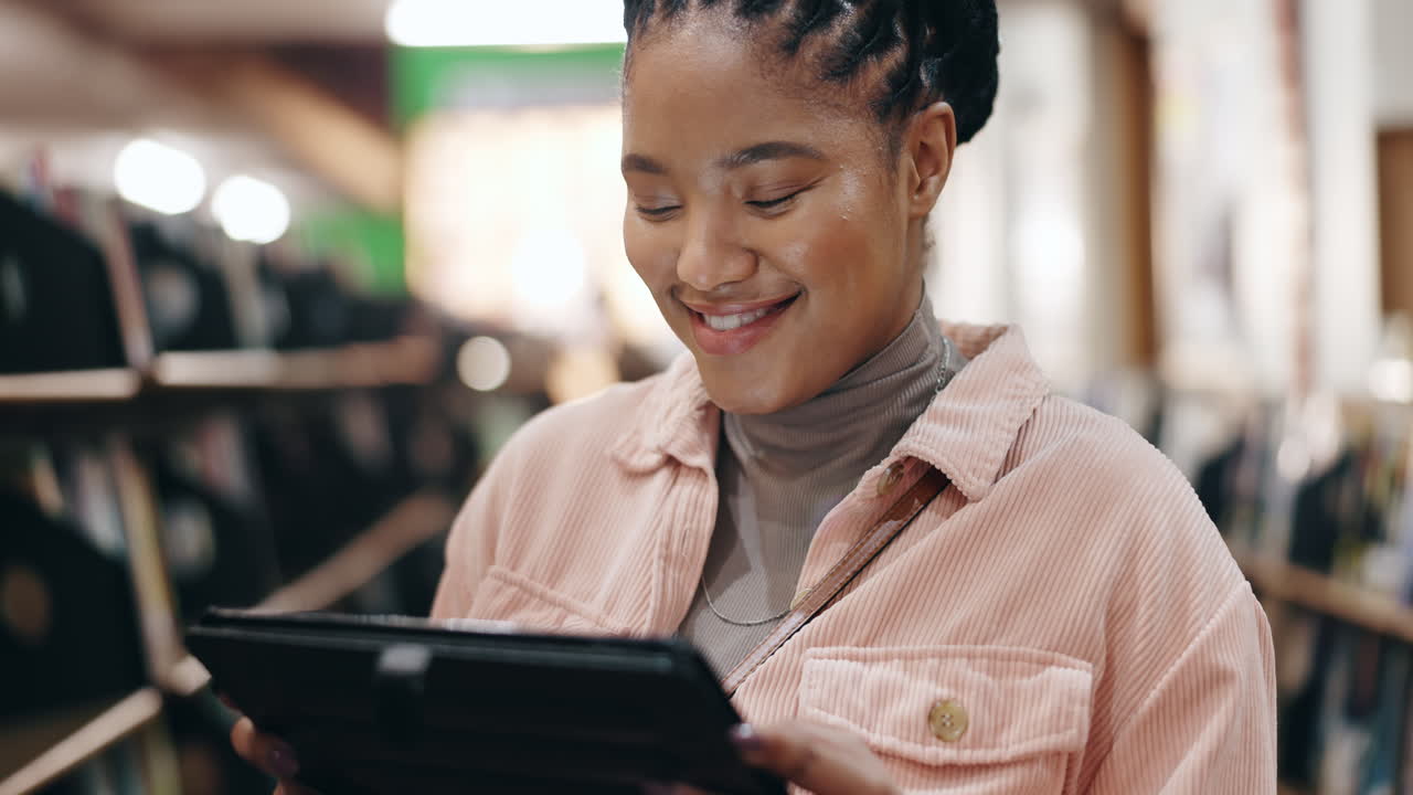 Woman using a tablet in a bookstore