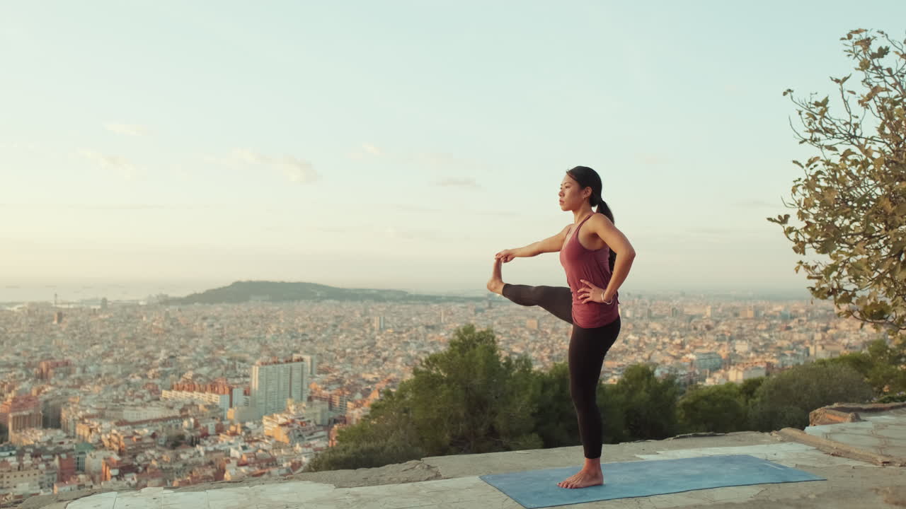 Woman Doing Yoga Overlooking City