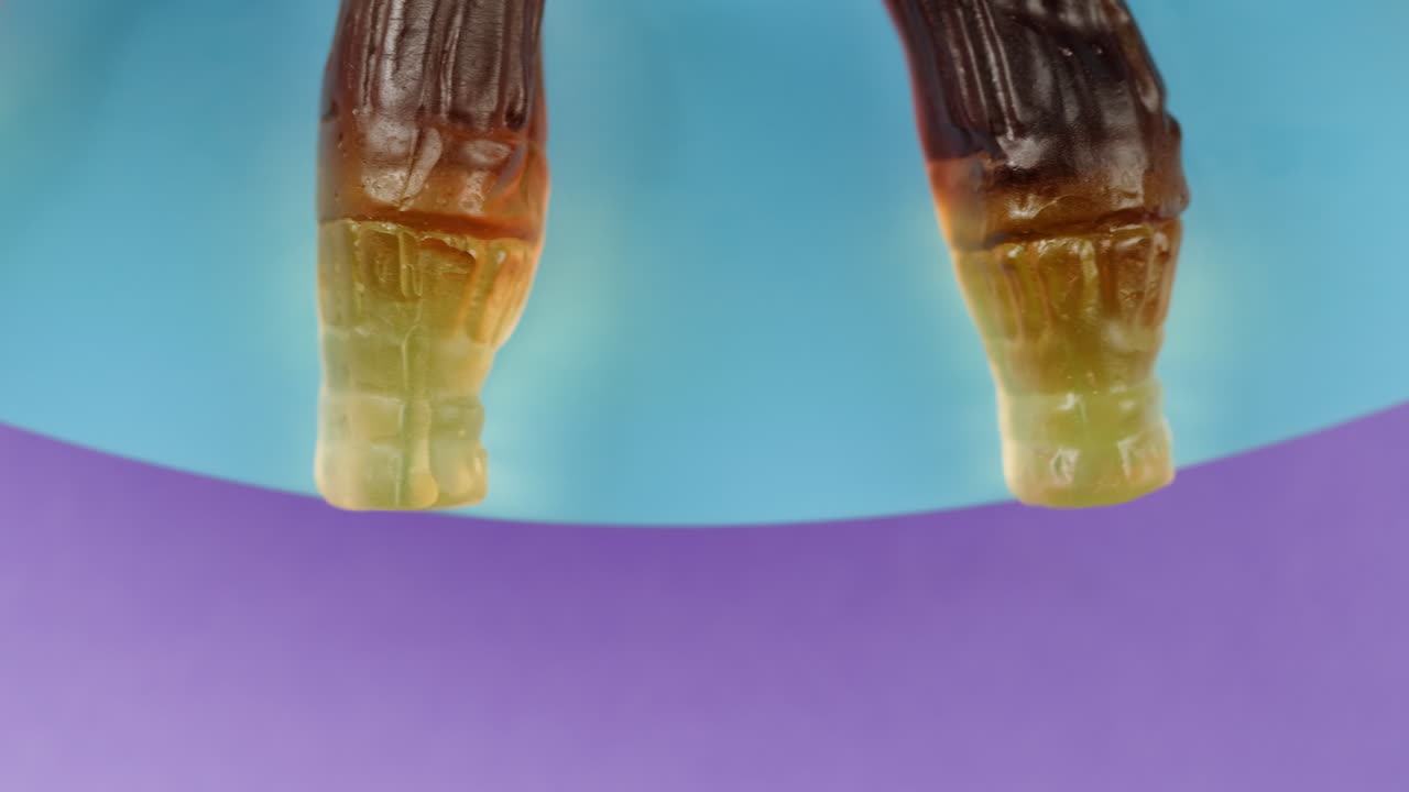 Gummy Cola Bottles on a Colorful Plate