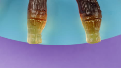gummy cola bottles on a colorful plate
