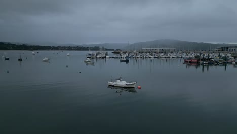 boats float in the waters of the ría de ares nautical club, spain