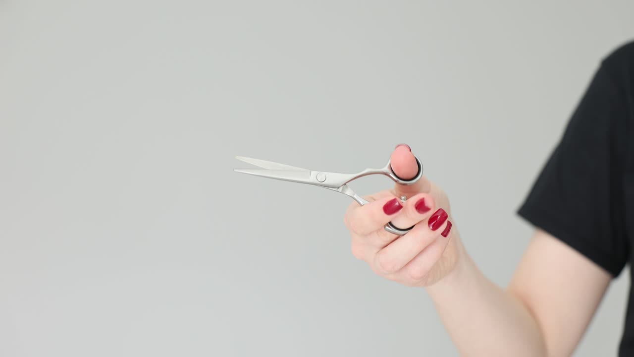 Hand Holding Hairdressing Scissors