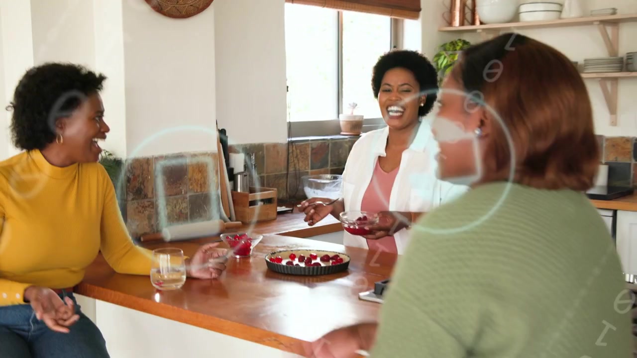 Friends gathering leading host placing raspberries into tart on kitchen island, sharing dessert