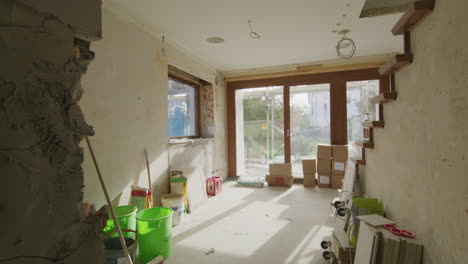 wide shot of a construction site in a german one family house, a lot of tools and bags on the ground