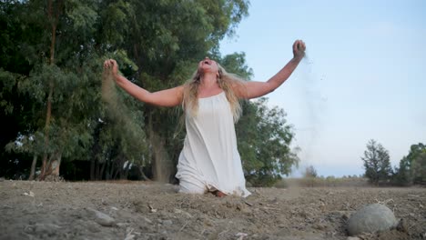 an emotional woman screaming on her knees in the dirt