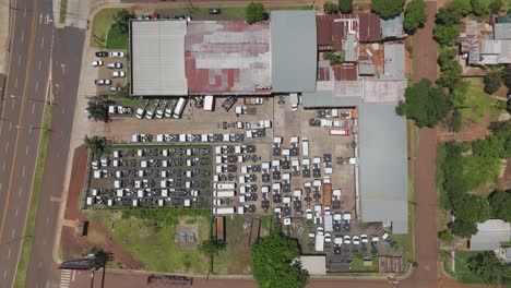 an overhead shot of a car dealership in misiones, argentina as the camera moves down