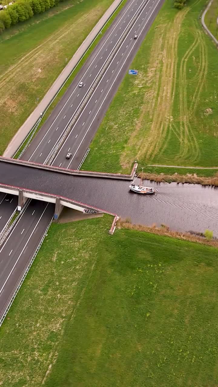 Boat Crossing Highway Bridge Over Canal
