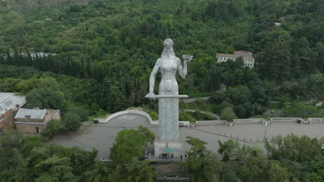 Aerial-shot-of-the-Mother-of-Georgia-monument-during-a-cloudy-day-in-Tbilisi