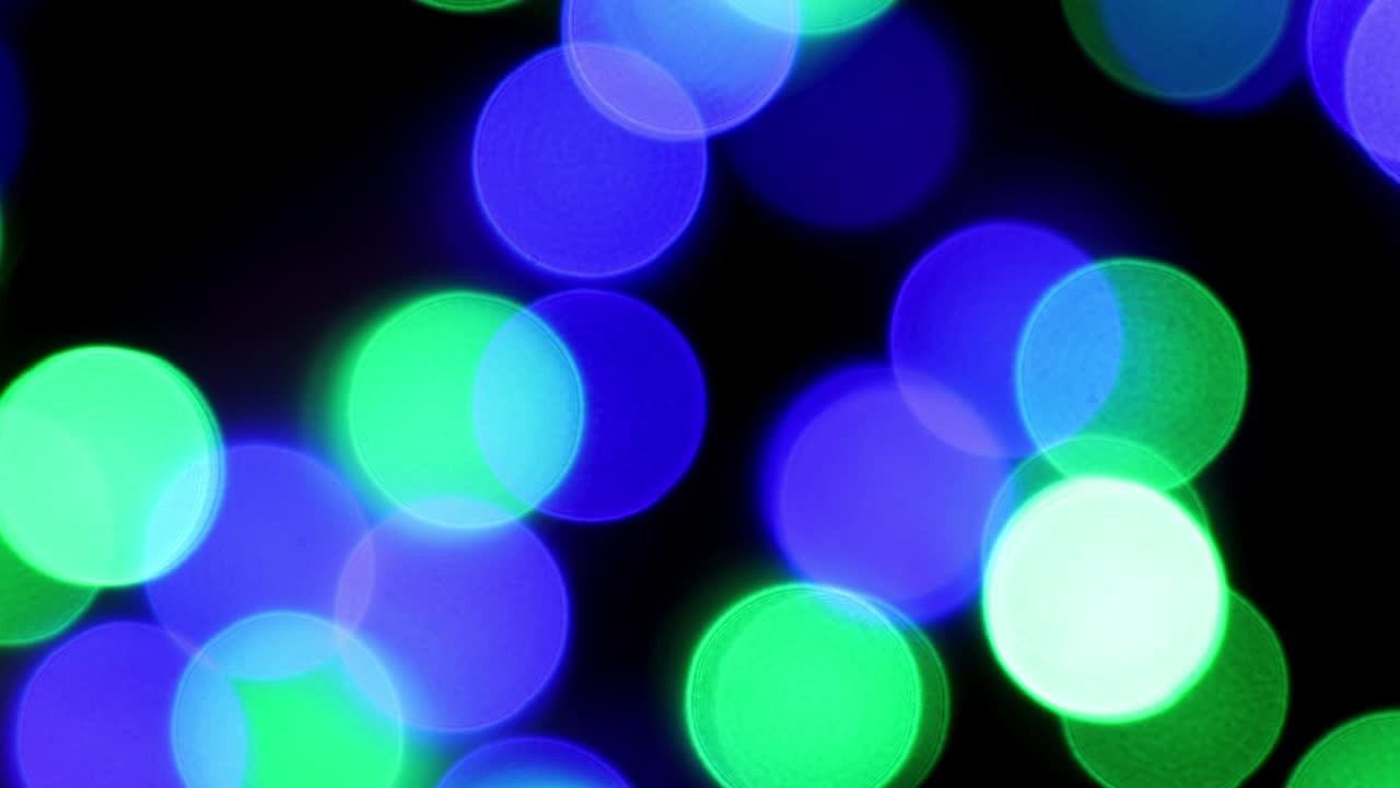 colorful bokeh background in red, green, blue, white, orange. Light from New Year and Christmas electric garlands, blurred background. Holiday concept