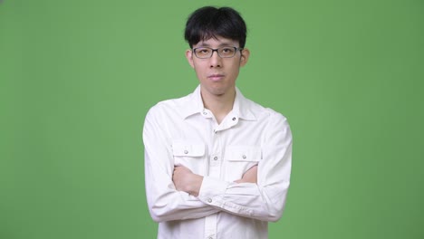 young asian businessman with arms crossed