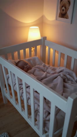 baby sleeping in a crib at night