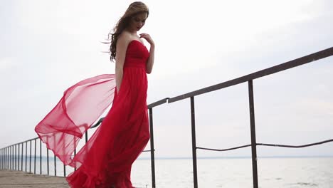 woman in red dress on a pier