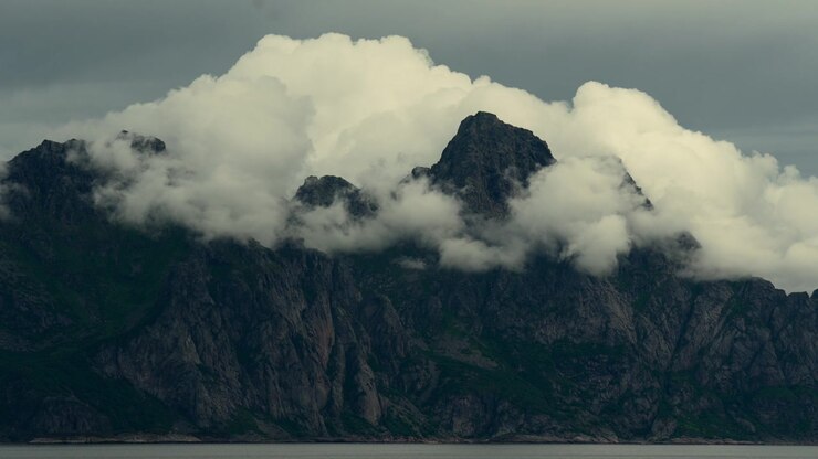 Clouds Settle Over Mountains Along The Coast Of Norway With Shifting Light.