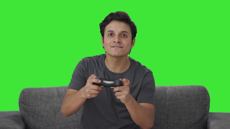Indian man playing video games Green screen