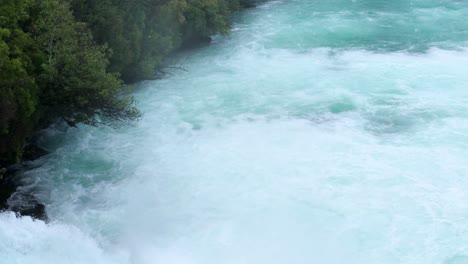 lower part of huka falls waterfalls of the waikato river, pan to the left