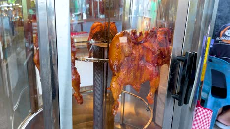 rotating roasted chicken at a floating market