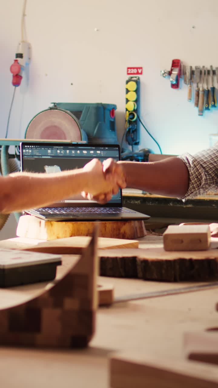 Craftsmen Shaking Hands and Discussing Design in Workshop