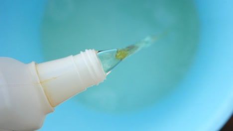 pouring liquid cleaning product into a bowl