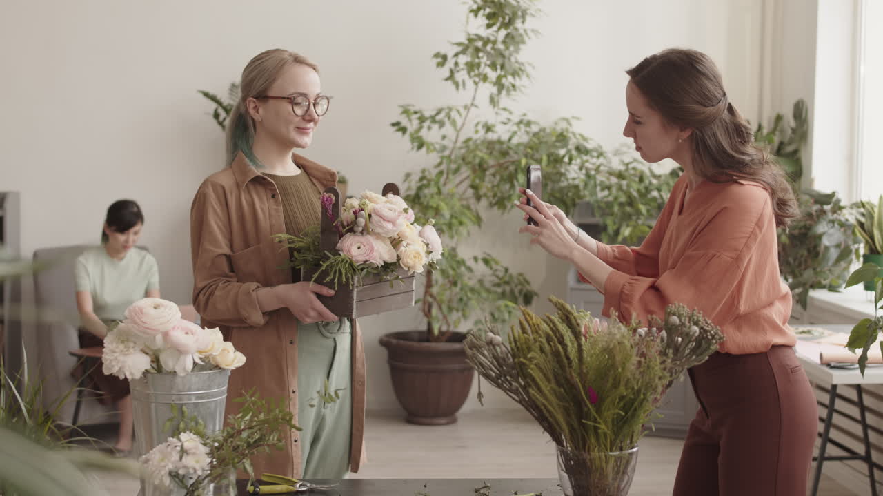 Two Women Photographing a Beautiful Floral Arrangement