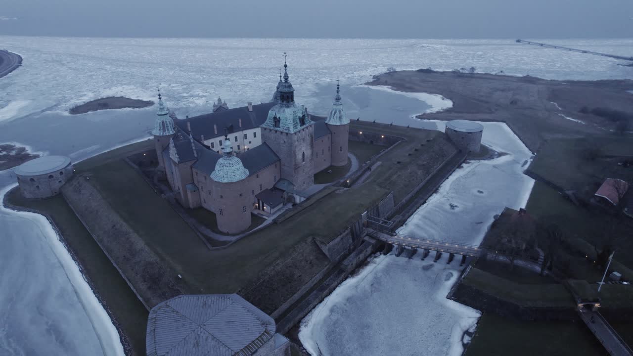 Cinematic aerial view of Kalmar Castle during winter