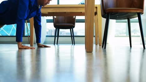 male executive doing pushups