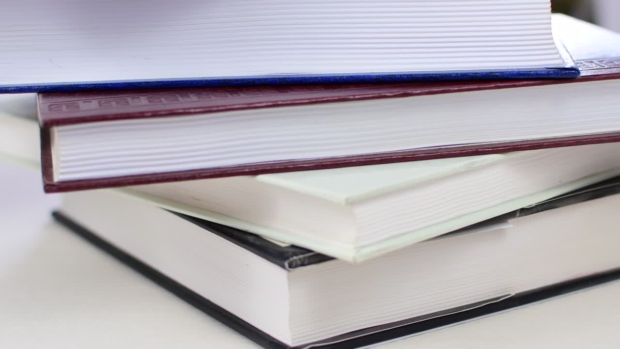 Desk with stack of study books. Textbooks for the student, university. Study from home. Distance education concept.