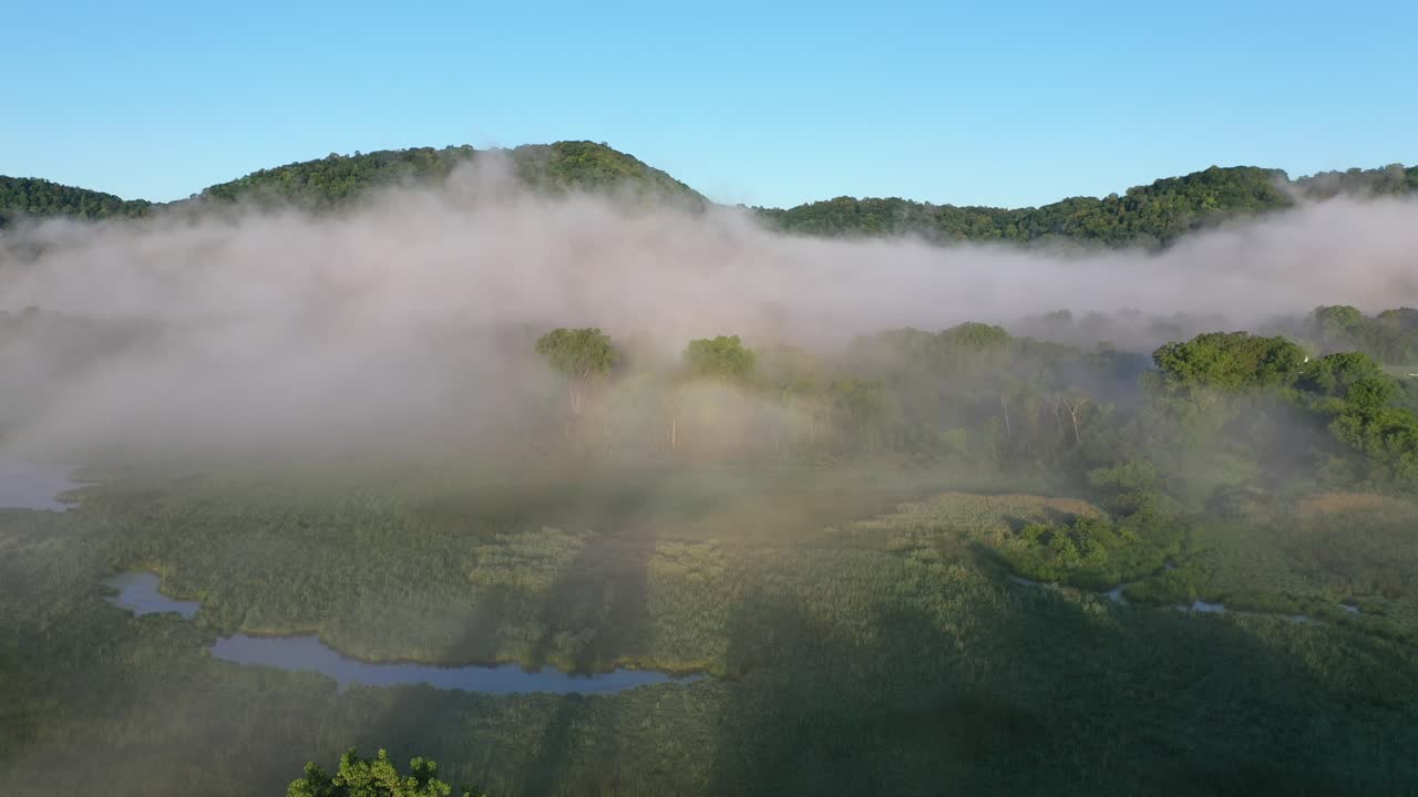 Misty Morning over Valley with Rainbow
