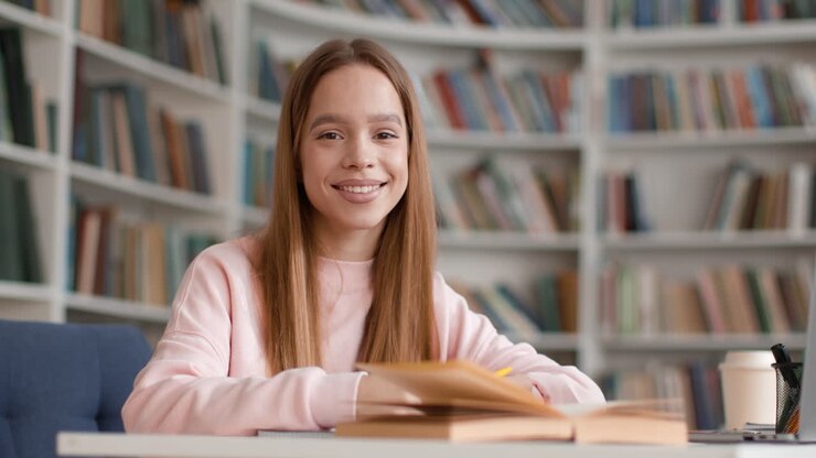 Un adolescente che studia in una biblioteca