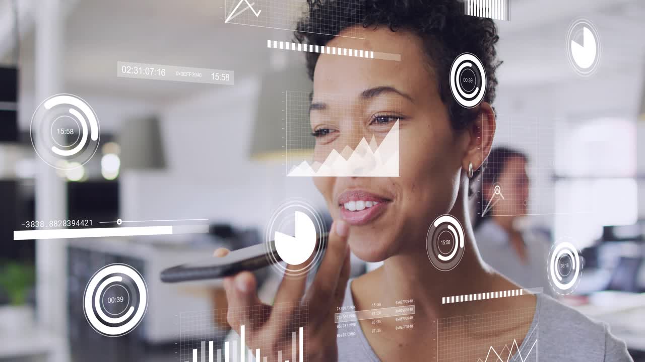 Woman using phone in open-plan office, lifting to mouth and speaking, charts syncing for business