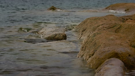 Waves-Splashing-On-Rocks-In-A-Lake---Slow-Motion
