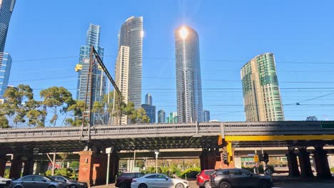 train moves across bridge with city backdrop