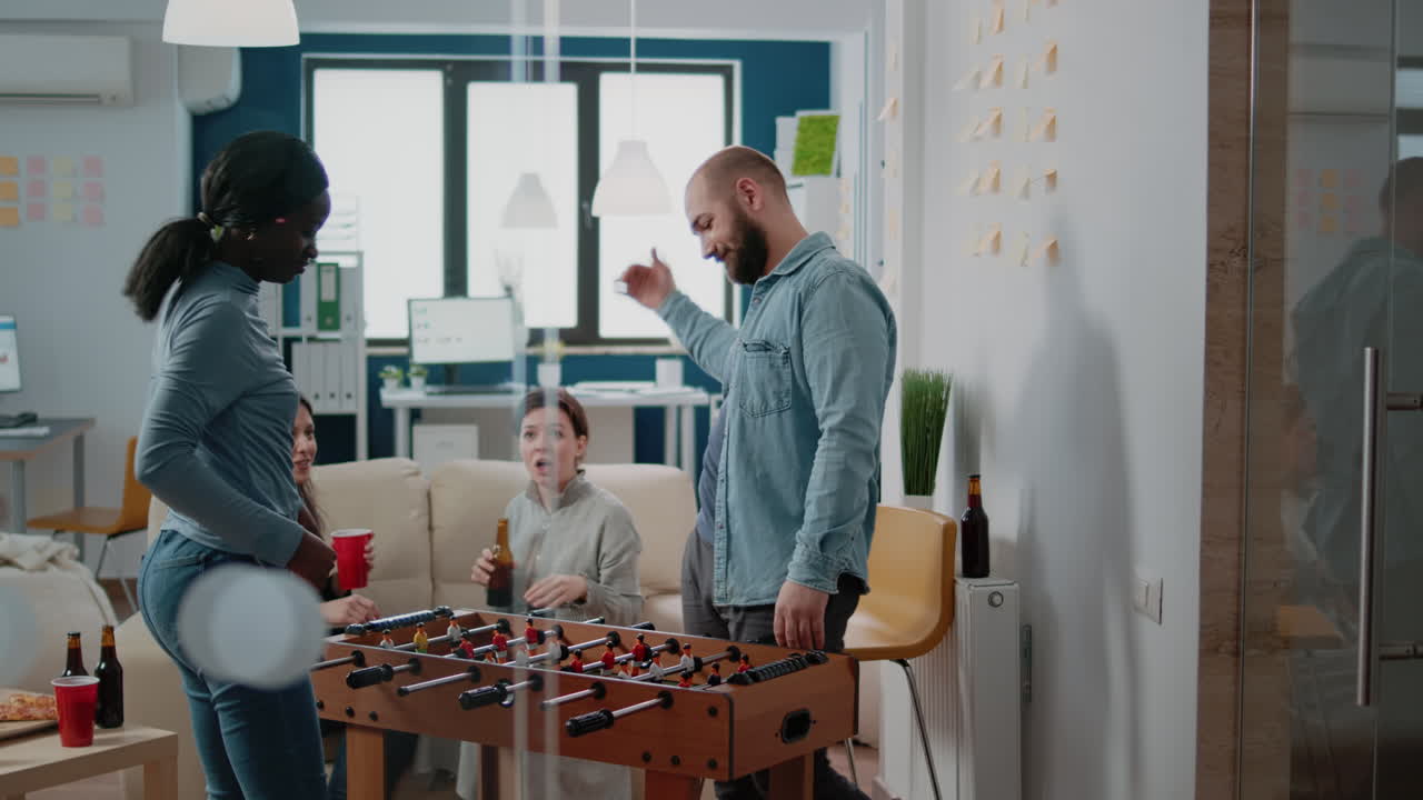 African american woman beating man at foosball game
