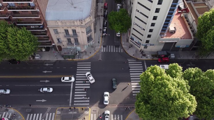 Aerial top-down rising over people walking on zebra crosswalk at Buenos Aires city, Argentine